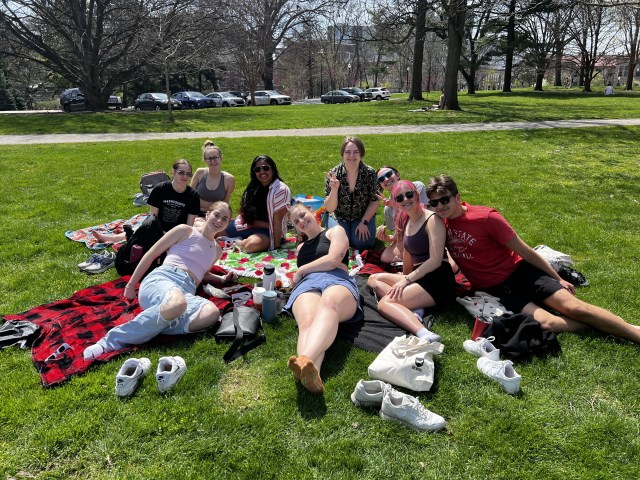Students sitting together outdoors near Ohio State Alumnae Scholarship Housing.